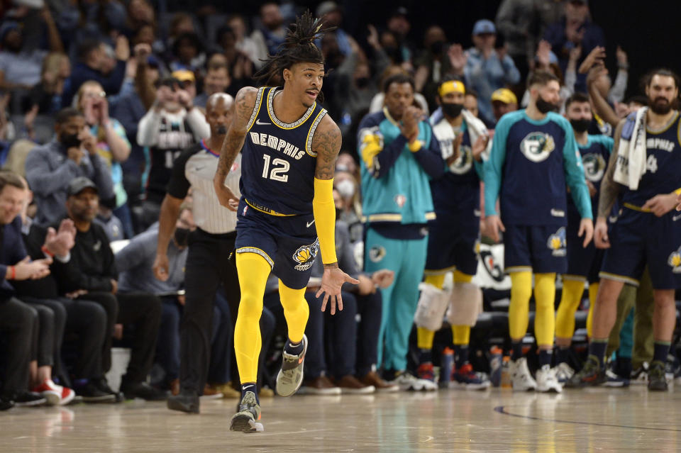 Memphis Grizzlies guard Ja Morant (12) reacts in the second half of an NBA basketball game against the Utah Jazz Friday, Jan. 28, 2022, in Memphis, Tenn. (AP Photo/Brandon Dill)