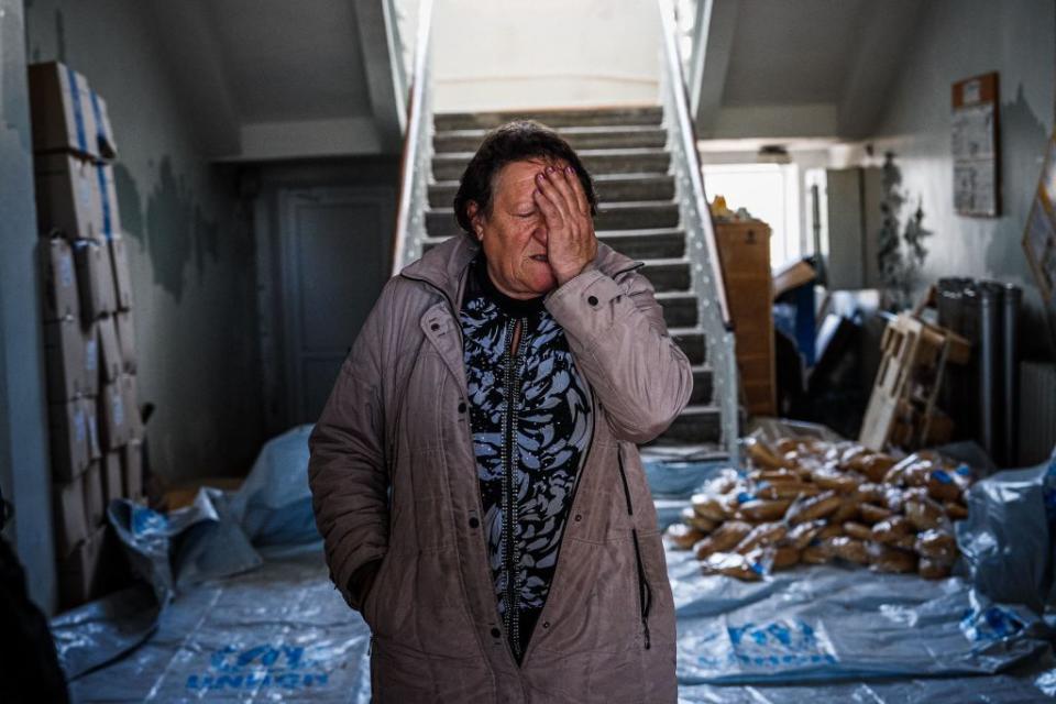 Olena Archipenko, 62 reacts as she prepared breads to be distributed to her neighbors in Siversk, Donetsk region on May 2, 2023, amid the Russian invasion of Ukraine. (Photo by Dimitar Dilkoff/AFP via Getty Images)