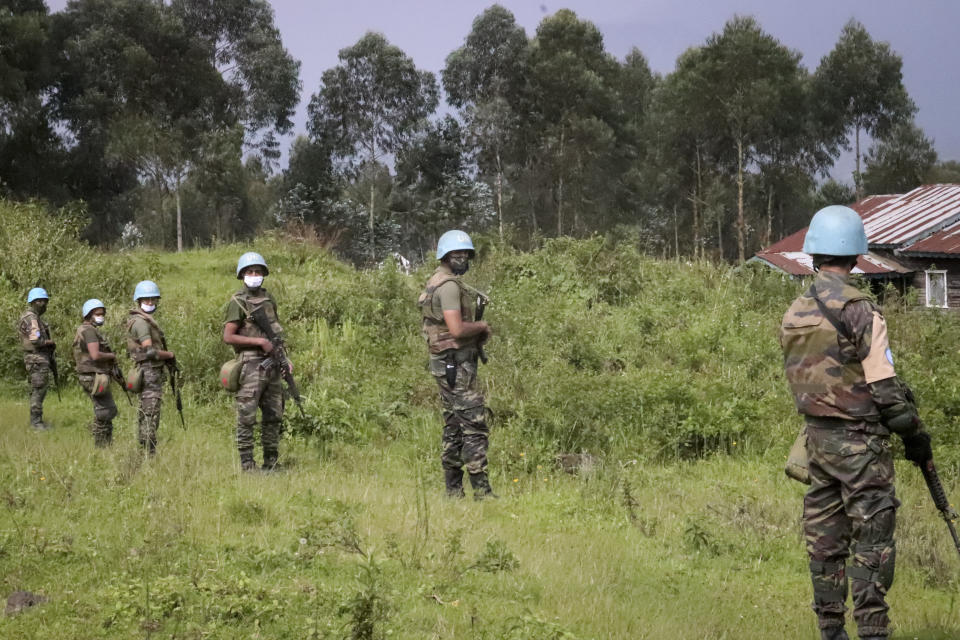 CORRECTS PHOTOGRAPHER BYLINE - United Nations peacekeepers guard the area where a U.N. convoy was attacked and the Italian ambassador to Congo killed, in Nyiragongo, North Kivu province, Congo Monday, Feb. 22, 2021. The Italian ambassador to Congo Luca Attanasio, an Italian carabineri police officer and their Congolese driver were killed Monday in an attack on a U.N. convoy in an area that is home to myriad rebel groups, the Foreign Ministry and local people said. (AP Photo/Justin Kabumba)