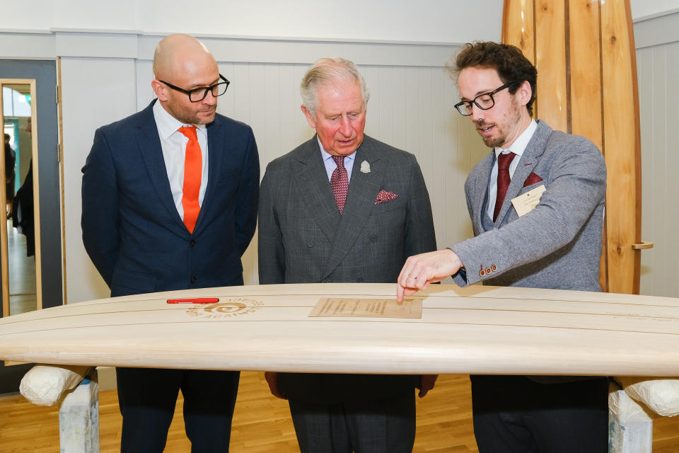 The Prince of Wales with James Otter (right) as he attends a reception in Newquay, Cornwall, to celebrate the 30th anniversary of Surfers Against Sewage and officially opens the Nansledan development school.