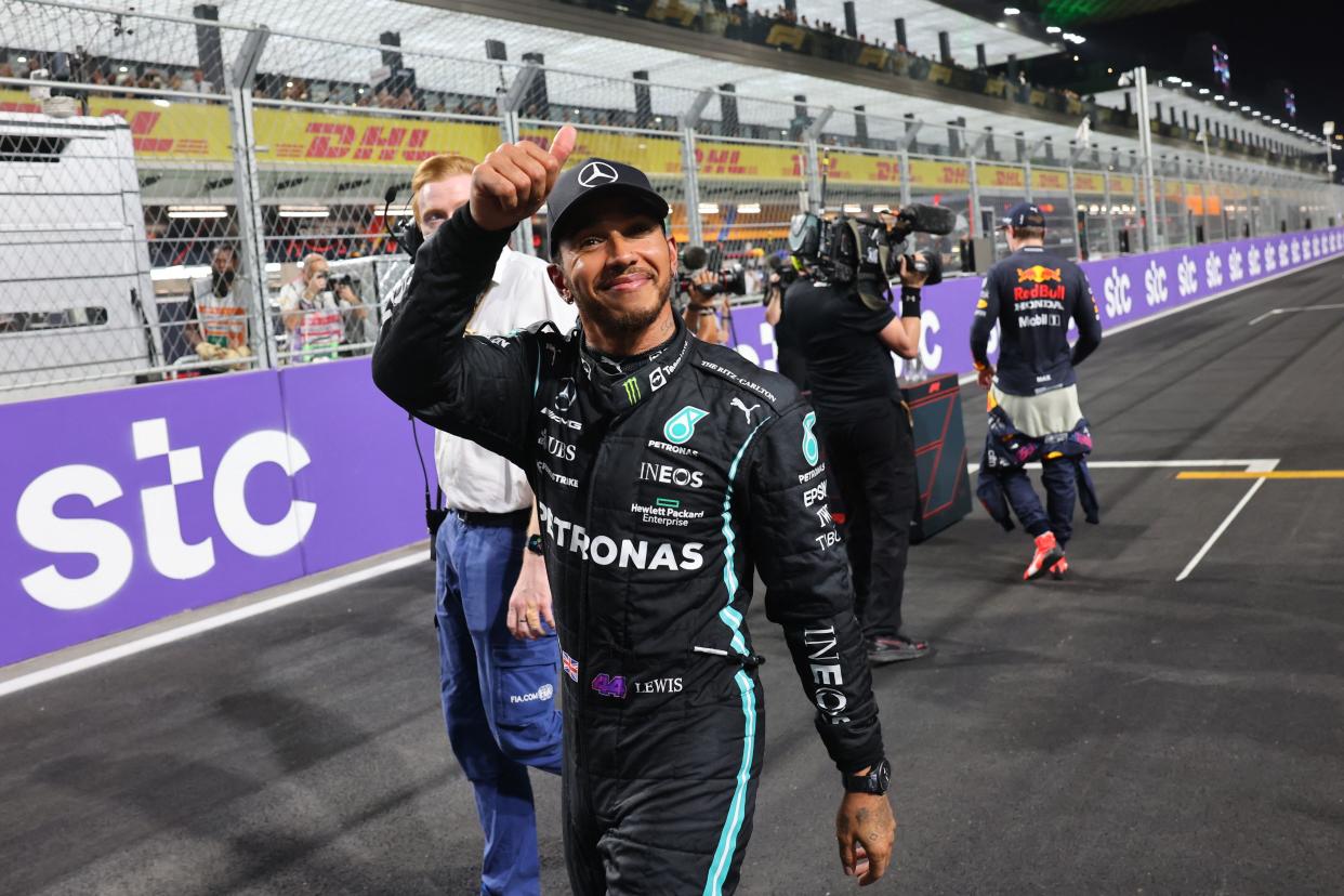 Lewis Hamilton reacts in the parc ferme after taking pole position.