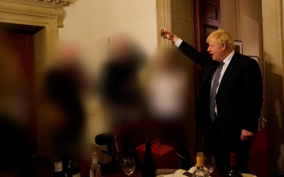 The Prime Minister can be seen raising a glass with aides in Downing Street in one of the photos released in the report - Microsoft Office User 