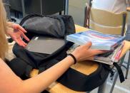 A pupil shows the content of her backpack during an English lesson at Pohjolanrinne middle school in Riihimaki