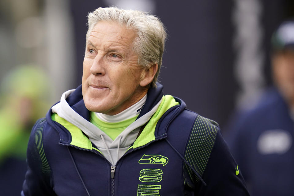 FILE - Seattle Seahawks head coach Pete Carroll walks on the field before an NFL football game against the San Francisco 49ers, on Dec. 5, 2021, in Seattle. NFL, which reports 94.4% of players are fully vaccinated, has not yet made COVID-19 booster shots part of its protocol. Carroll said the Seahawks scheduled a booster day for players, coaches and staff this week. (AP Photo/Elaine Thompson, File)