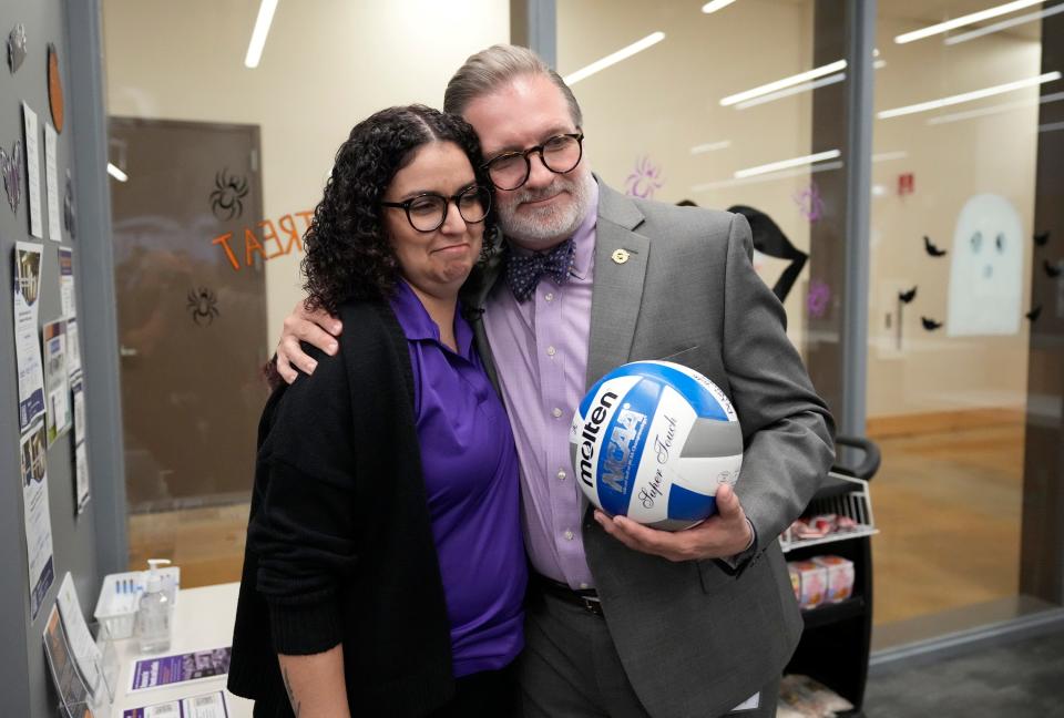 Lowery-Hart hugs Lela Jamalabad, regional coordinator of student life, during a tour of the student life lounge at the Highland campus.