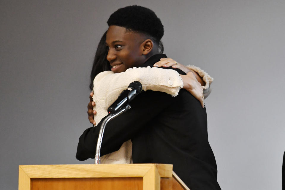 The Duchess of Sussex (left) embraces head boy Aker Okoye, in a school assembly, during her surprise visit to the Robert Clack Upper School in Dagenham, Essex, to celebrate International Women's Day.