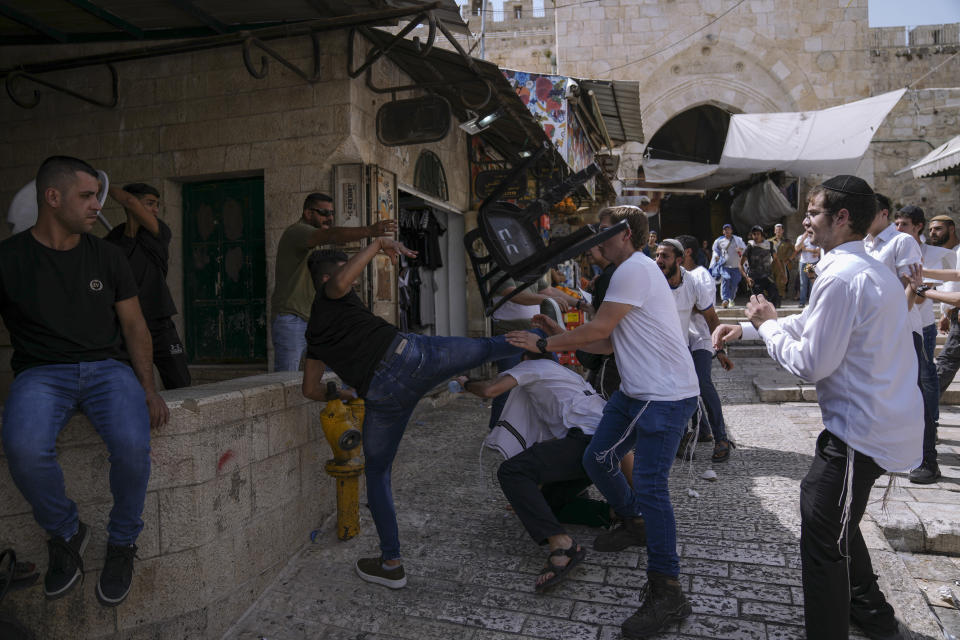 Palestinians and Jewish youths clash in Jerusalem's Old City as Israelis mark Jerusalem Day, an Israeli holiday celebrating the capture of the Old City during the 1967 Mideast war. Sunday, May 29, 2022. Israel claims all of Jerusalem as its capital. But Palestinians, who seek east Jerusalem as the capital of a future state, see the march as a provocation. Last year, the parade helped trigger an 11-day war between Israel and Gaza militants. (AP Photo/Ariel Schalit)