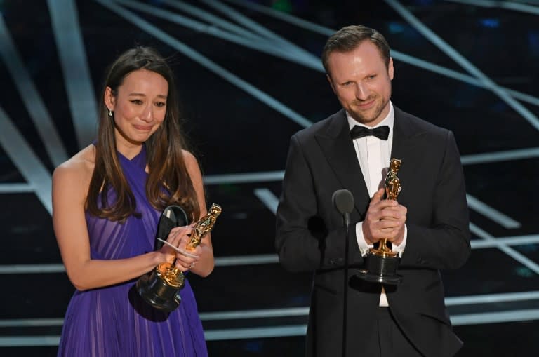 Orlando von Einsiedel (R) and Joanna Natasegara address the audience at the 89th Oscars on February 26, 2017 in Hollywood, California