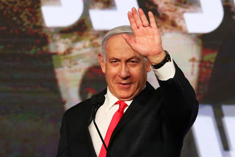 FILE PHOTO: Israeli Prime Minister Benjamin Netanyahu gestures as he delivers a speech to supporters following the announcement of exit polls in Israel's general election at his Likud party headquarters in Jerusalem