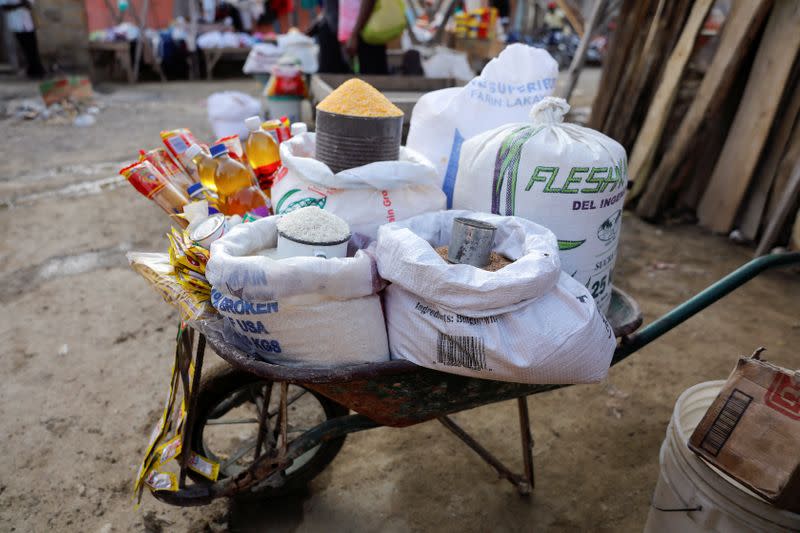 Necessities such as cooking oil and grains are seen for sale at a street market in Jean-Rebel