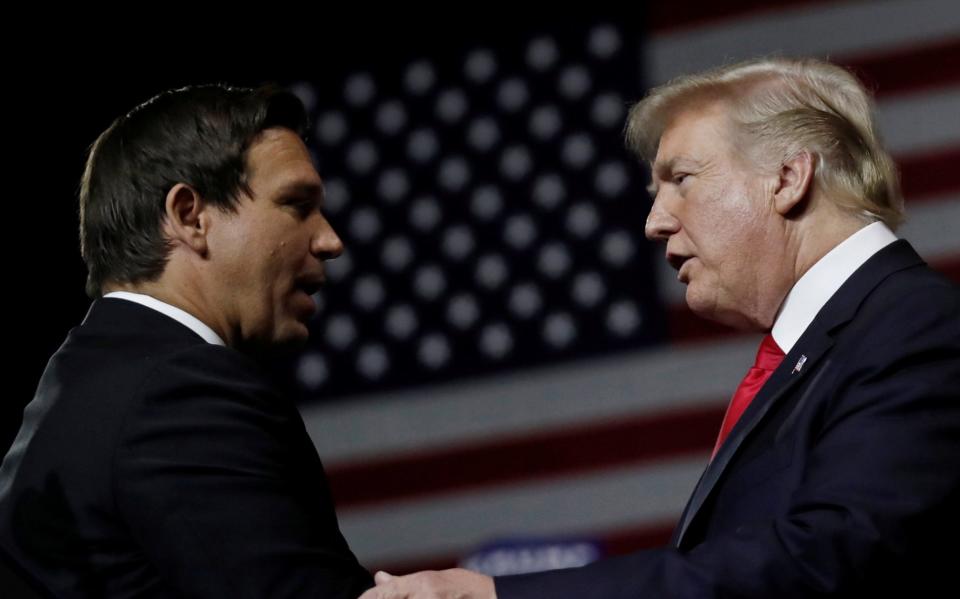 President Donald Trump talking with Ron DeSantis during a Make America Great Again Rally in Florida in 2018 - Carlos Barria/Reuters