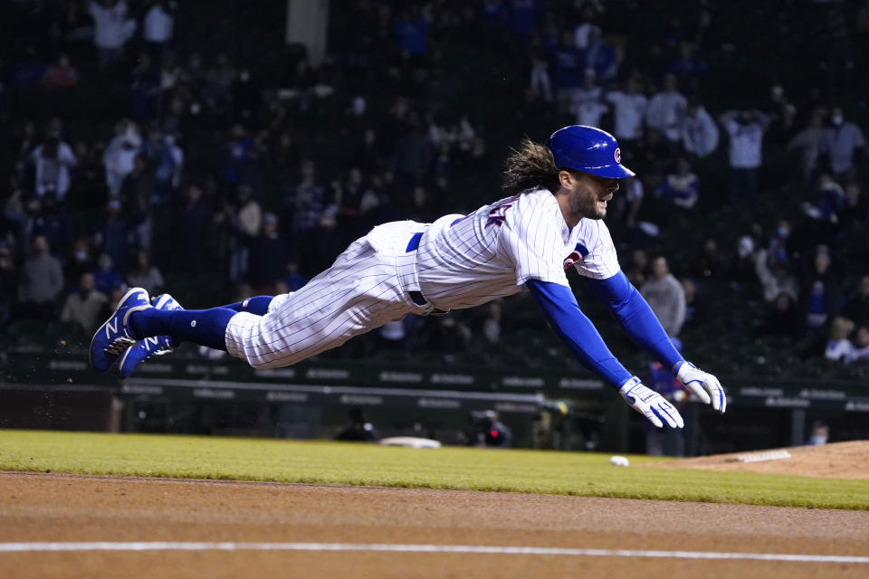 Chicago Cubs' Jake Marisnick (6) dives into third base with a triple against the New York Mets during the eighth inning of a baseball game, Thursday, April, 22, 2021, in Chicago. (AP Photo/David Banks)