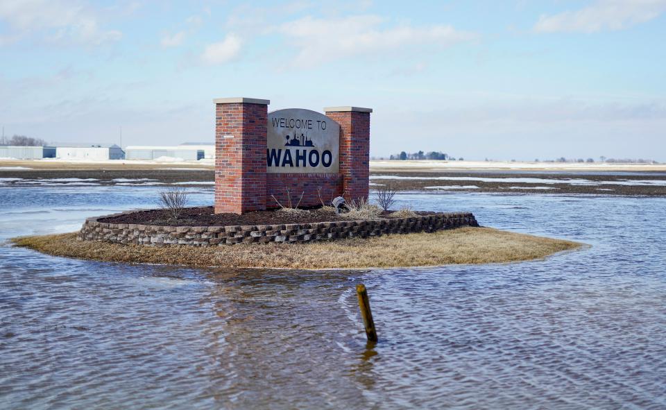 A Welcome to Wahoo sign stands in flood waters outside Wahoo, Neb., Wednesday, March 13, 2019. Record flooding swamped the central U.S. this week.