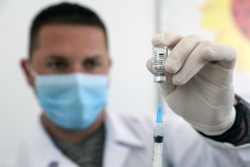 A member of the medical staff prepares a dose of the Sinovac COVID-19 vaccine, also know as CoronaVac, during a mass vaccination program at Skanderbeg Square in Tirana, Albania, Thursday, April 15, 2021. Albania has made virus slabs to almost 300,000 people, starting with the medical personnel, eldest people and schoolteachers to achieve a mass inoculation campaign ahead of the summer tourism season. (AP Photo)