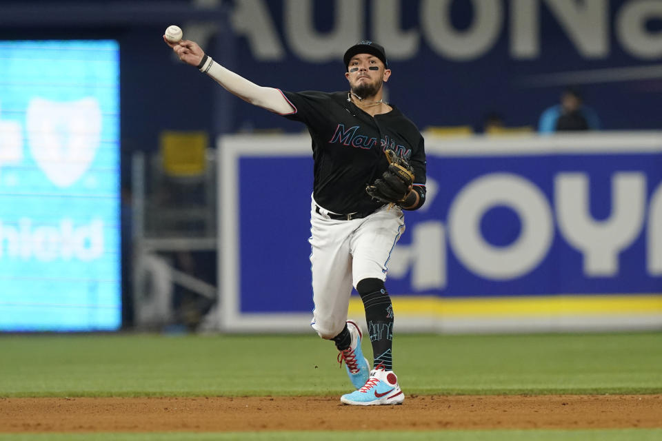 Miami Marlins shortstop Miguel Rojas (11) throws to first base on a hit by Washington Nationals' Lane Thomas during the fifth inning of a baseball game, Friday, Sept. 23, 2022, in Miami. (AP Photo/Marta Lavandier)