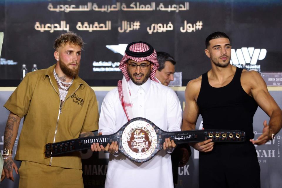 Jake Paul and Tommy Fury pose for a picture with the belt (AFP via Getty Images)