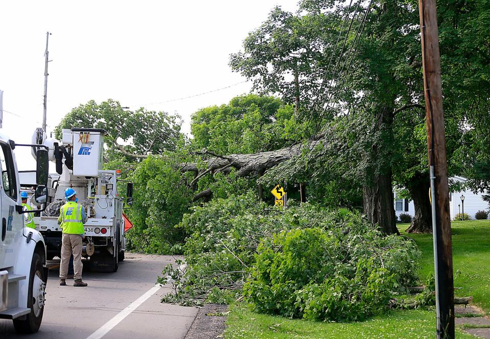 Crews from Haugland Energy from Melville, NY arrive at the site of the trees on the power lines over state Route 60 near Vermillion Cemetery in Hayesville on Wednesday, June 15, 2022. TOM E. PUSKAR/ASHLAND TIMES-GAZETTE