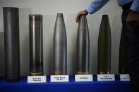 Richard Hansen, a Navy veteran and the Army commander's representative at the Scranton Army Ammunition Plant leans on a display during a tour of the manufacturing process of 155 mm M795 artillery projectiles, Tuesday, Aug. 27, 2024, in Scranton, Pa. (AP Photo/Matt Slocum)