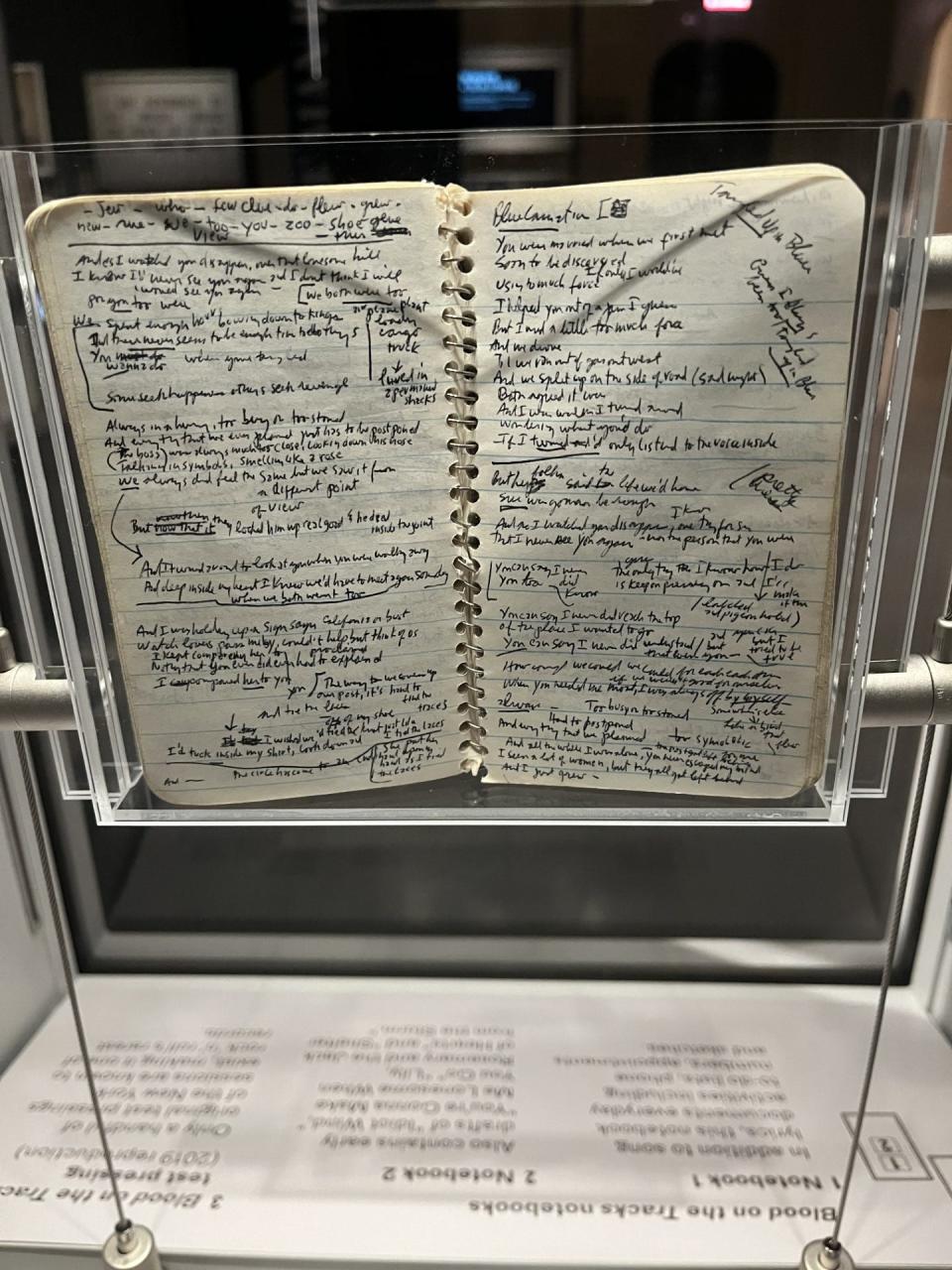 Notebook pages with some of Bob Dylan's handwritten lyrics.