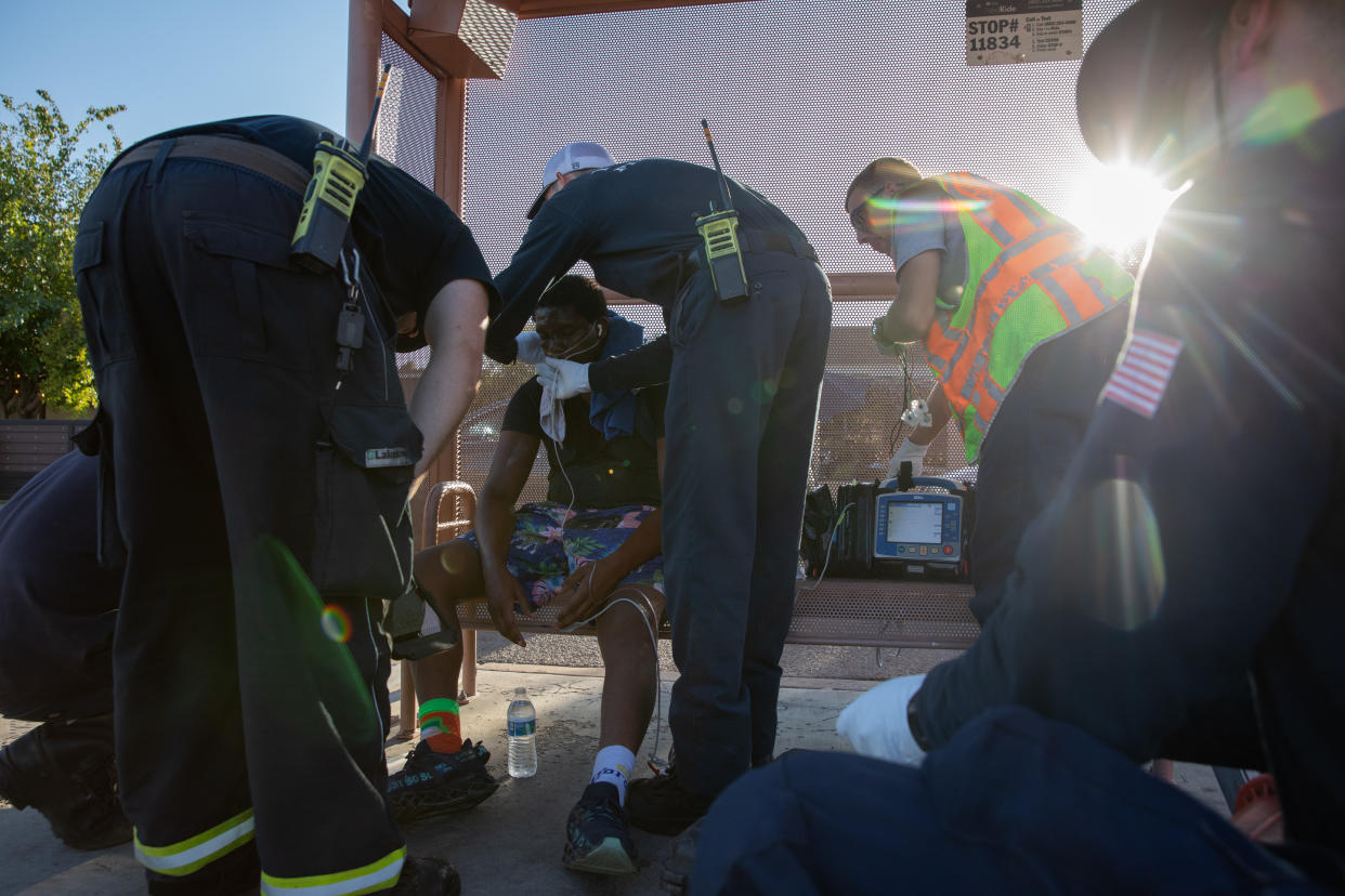 Firefighters help a resident with breathing trouble in Phoenix.