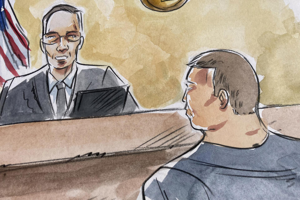 In this courtroom sketch, former tax collector Joel Greenberg appears before U.S. District Judge Gregory Presnell in federal court in Orlando, Fla., on Thursday, Dec. 1, 2022. Greenberg was sentenced to 11 years in prison for sex trafficking a minor and other crimes. His arrest two years ago led to a federal investigation of U.S. Rep. Matt Gaetz. (AP Photo/Neftali Melendez)