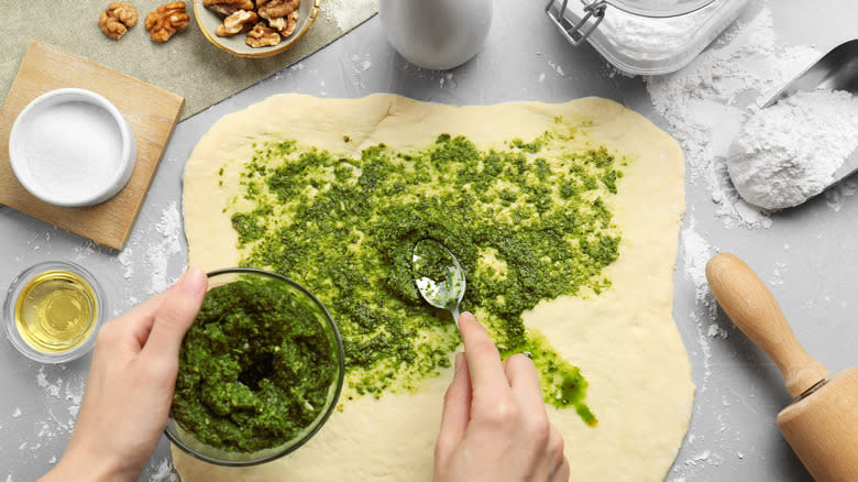 Pesto on pizza dough