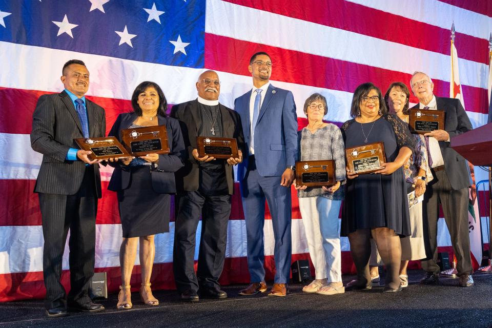 The six recipients of a key to the city pose for a photo with Mayor Kevin Lincoln, center, after during the 2023 State of the City on Thursday, May 18, 2023, at the Port of Stockton.