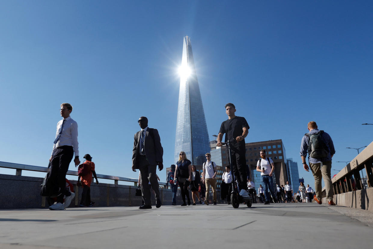 UK workers People walk on London Bridge in view of The Shard, the day after a national rail strike, during six days of travel disruption, in London, Britain, June 22, 2022. REUTERS/Peter Cziborra