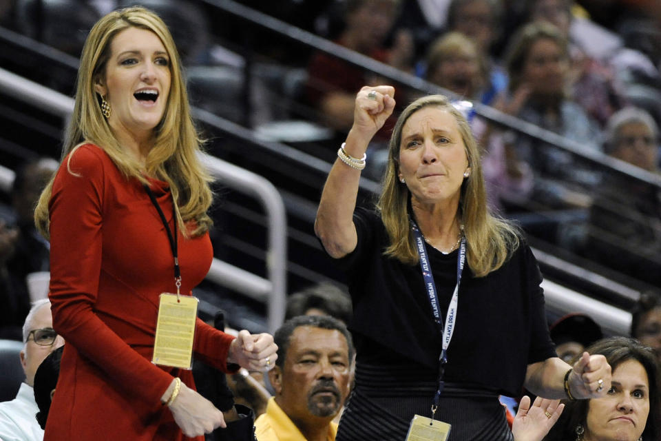 Kelly Loeffler (left), cheers on the Atlanta Dream basketball team, which she co-owns, during a game. She has become an outspoken opponent of a WNBA plan to publicly support the Black Lives Movement -- a position that has put her at odds with the Dream's players. (Photo: ASSOCIATED PRESS)