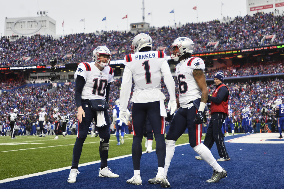 New England Patriots wide receiver DeVante Parker (1) celebrates his touchdown catch with quarterback Mac Jones (10) during the first half of an NFL football game against the Buffalo Bills, Sunday, Jan. 8, 2023, in Orchard Park. (AP Photo/Adrian Kraus)