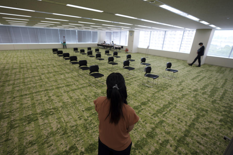 The waiting area for the Moderna's COVID-19 vaccine shot is seen at the office building of the beverage maker Suntory as the company began its workplace vaccination Monday, June 21, 2021, in Tokyo. Thousands of Japanese companies began distributing COVID-19 vaccines to workers and their families Monday in an employer-led drive reaching more than 13 million people that aims to rev up the nation's slow vaccine rollout. (AP Photo/Eugene Hoshiko)