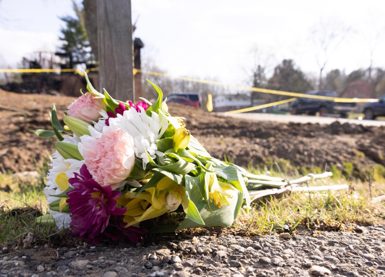 Flowers were left at the front of this Jackson Township home where fire swept through early Sunday killing four people inside.