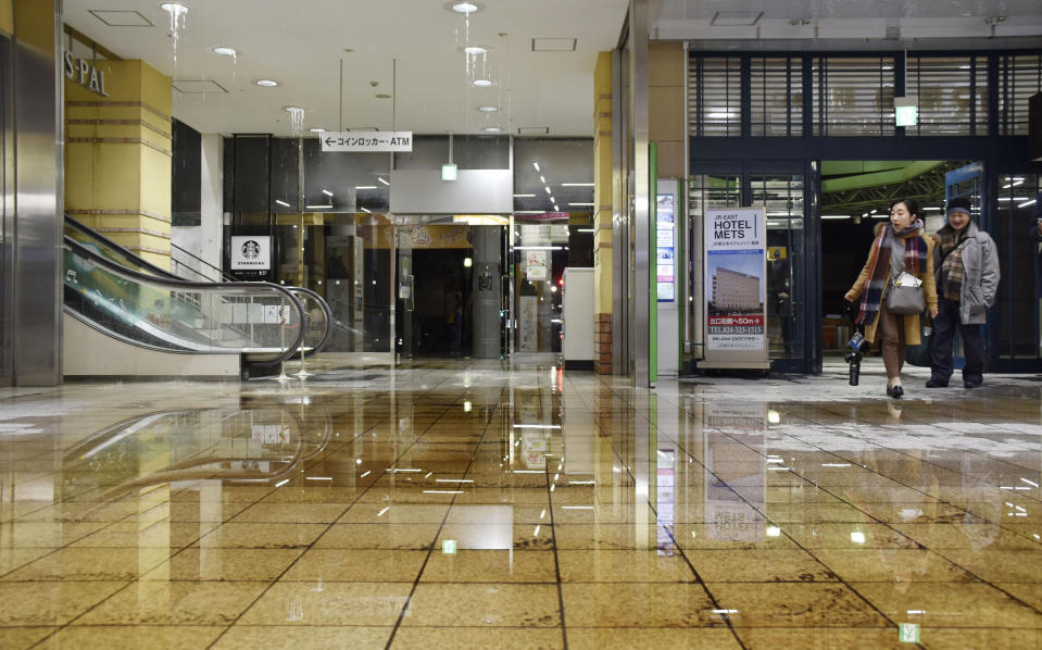Water covers a floor of Fukushima station as it leaks from a ceiling following an earthquake in Fukushima, northeastern Japan Saturday, Feb. 13, 2021. A strong earthquake hit off the coast of northeastern Japan late Saturday, shaking Fukushima, Miyagi and other areas, but there was no threat of a tsunami, officials said. (Kyodo News via AP)