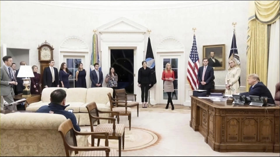 This exhibit from video released by the House Select Committee, shows then-President Donald Trump in the Oval Office on Jan. 5, 2021, with the door open so he could hear supporters at Freedom Plaza, displayed at a hearing by the House select committee investigating the Jan. 6 attack on the U.S. Capitol, Thursday, Oct. 13, 2022, on Capitol Hill in Washington. (House Select Committee via AP)