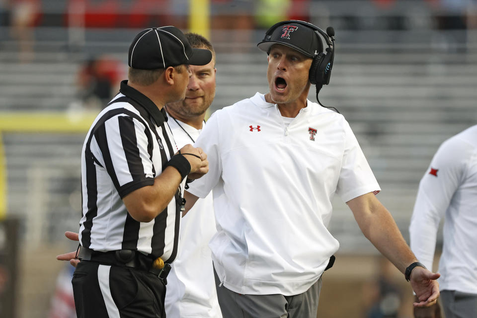 Texas Tech coach Matt Wells argues a call with head linesman Matt Burks during the first half of the team's NCAA college football game against Texas Tech, Saturday, Sept. 11, 2021, in Lubbock, Texas. (AP Photo/Brad Tollefson)