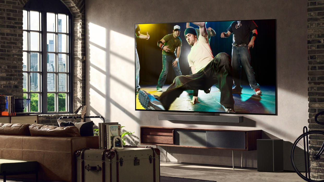  LG G3 OLED TV in a modern apartment living room with a break dancers on screen. 