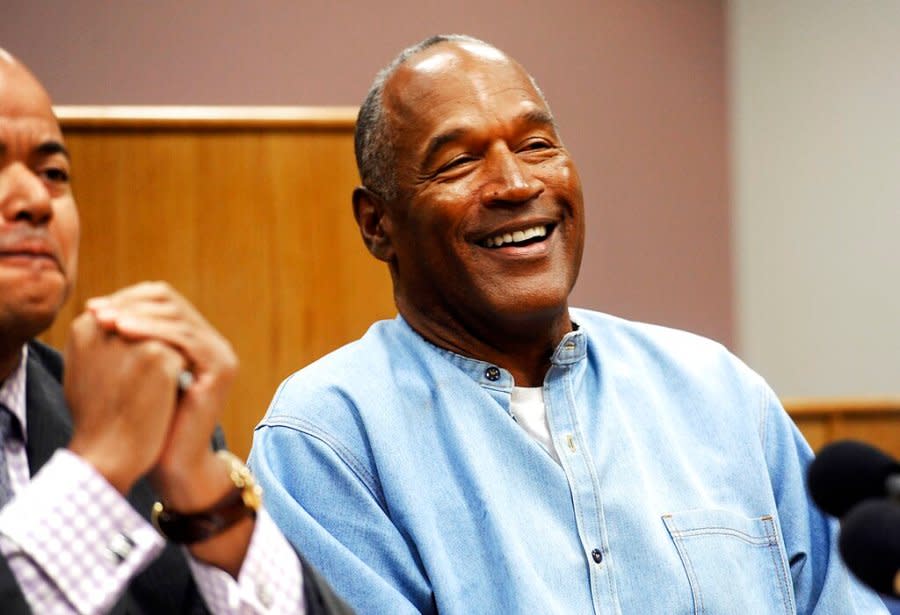 In this July 20, 2017, file photo, former NFL football star O.J. Simpson reacts after learning he was granted parole at Lovelock Correctional Center in Lovelock, Nev. Simpson got into a series of minor legal scrapes following his 1995 acquittal of murder charges in the deaths of his wife Nicole Brown Simpson and her friend Ronald Goldman. (Jason Bean/The Reno Gazette-Journal via AP, Pool, File)