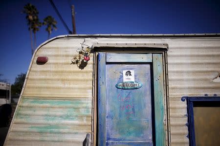 A welcome sign is seen on the door of a caravan in a homeless motorhome and tent encampment near LAX airport in Los Angeles, California, United States, October 26, 2015. REUTERS/Lucy Nicholson