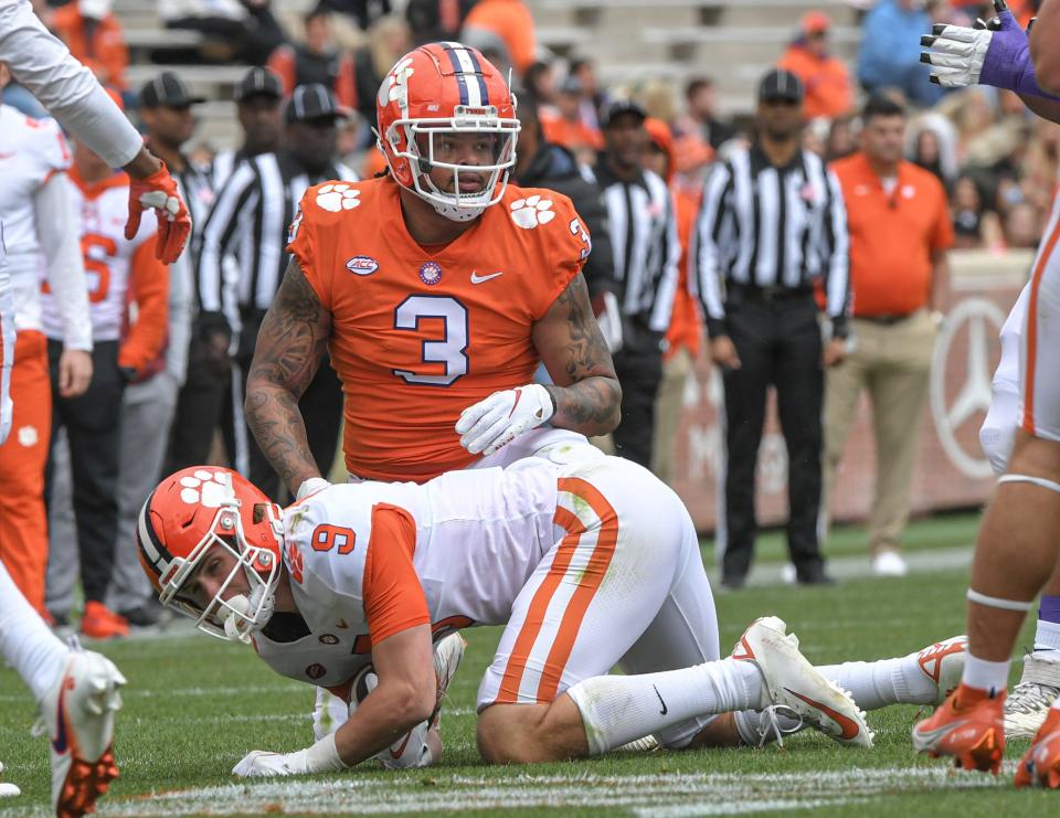 Orange squad defensive end Xavier Thomas (3) tackles White squad tight end Jake Briningstool (9) during the second quarter of the 2022 Orange vs White Spring Game at Memorial Stadium in Clemson, South Carolina Apr 9, 2022; Clemson, South Carolina, USA;  at Memorial Stadium. 