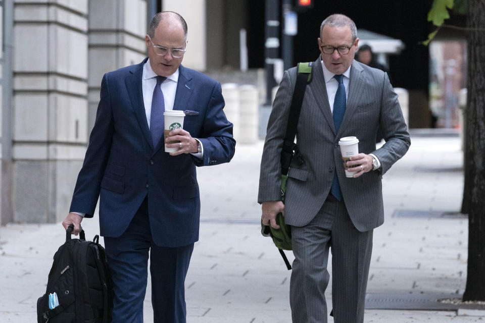 Attorneys of Oath Keepers leader Stewart Rhodes, Phillip Linder, left, and James Lee Bright, arrive at the Federal Courthouse during the Rhodes trial in Washington, Tuesday, Oct. 4, 2022. The founder of the Oath Keepers extremist group and four associates planned an "armed rebellion" to keep President Donald Trump in power, a federal prosecutor contended Monday, as the most serious case yet went to trial in the Jan. 6, 2021, attack on the U.S. Capitol. ( AP Photo/Jose Luis Magana)