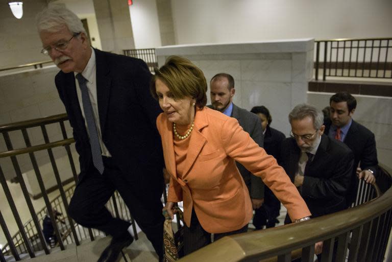 House Minority Leader Nancy Pelosi (R) leaves a meeting of House Democrats on Capitol Hill December 11, 2014 in Washington, DC