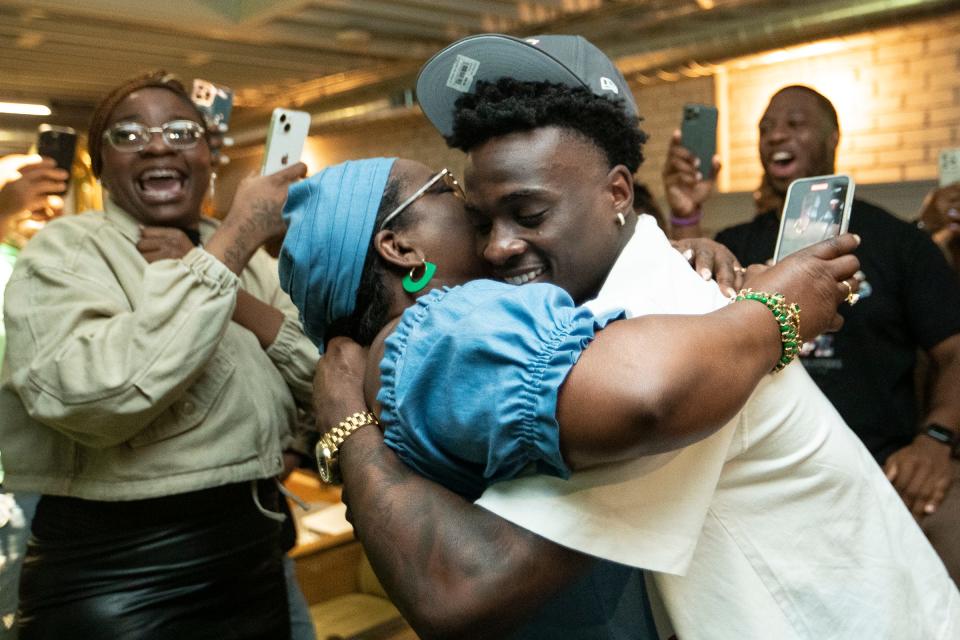 Former Michigan defensive back Mike Sainristil hugs his mother Raymonde Sainristil to celebrate being drafted by Washington Commanders during his NFL Draft watch party in Ann Arbor on Friday, April 26, 2024.