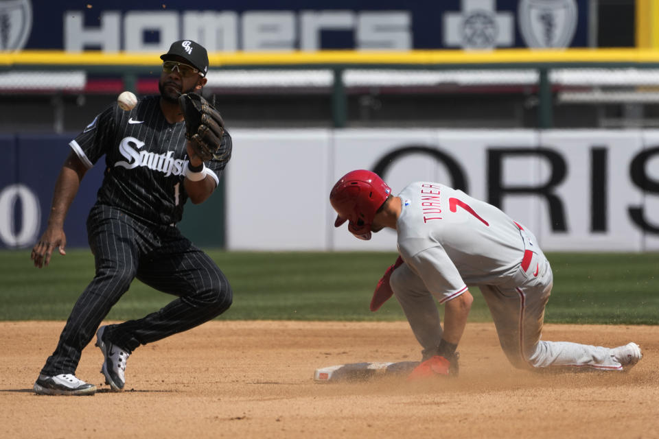 Philadelphia Phillies' Trea Turner steals second as Chicago White Sox's Elvis Andrus fields the throw from catcher Yasmani Grandal during the third inning of a baseball game Wednesday, April 19, 2023, in Chicago. (AP Photo/Charles Rex Arbogast)