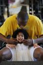 Kobe Bryant of the Los Angeles Lakers pinches his daughter Gianna Bryant's cheeks during a photo session on March 29, 2008 at his home in Newport Beach, California. (Photo by Andrew D. Bernstein/NBAE via Getty Images)