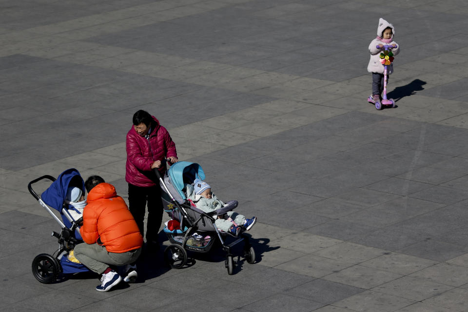 In this Feb. 17, 2019, photo, Chinese people bring their babies to a park in Beijing. Facing a future demographic crisis and aging society, China's leaders are desperately seeking to persuade couples to have more children. But the country's bureaucrats don't seem to have gotten the message, fining a couple in a recent widely publicized case for having a third child against the strict letter of the law. (AP Photo/Andy Wong)