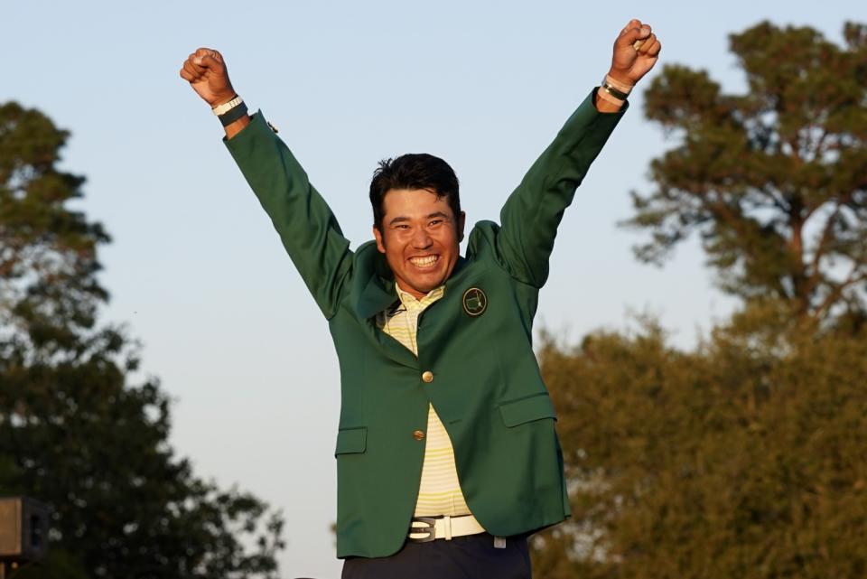 Hideki Matsuyama, of Japan, celebrates after putting on the Masters champion's green jacket