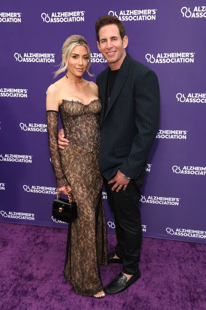 Heather Rae El Moussa in a strapless, lace gown with Tarek El Moussa in a suit at an Alzheimer's Association event