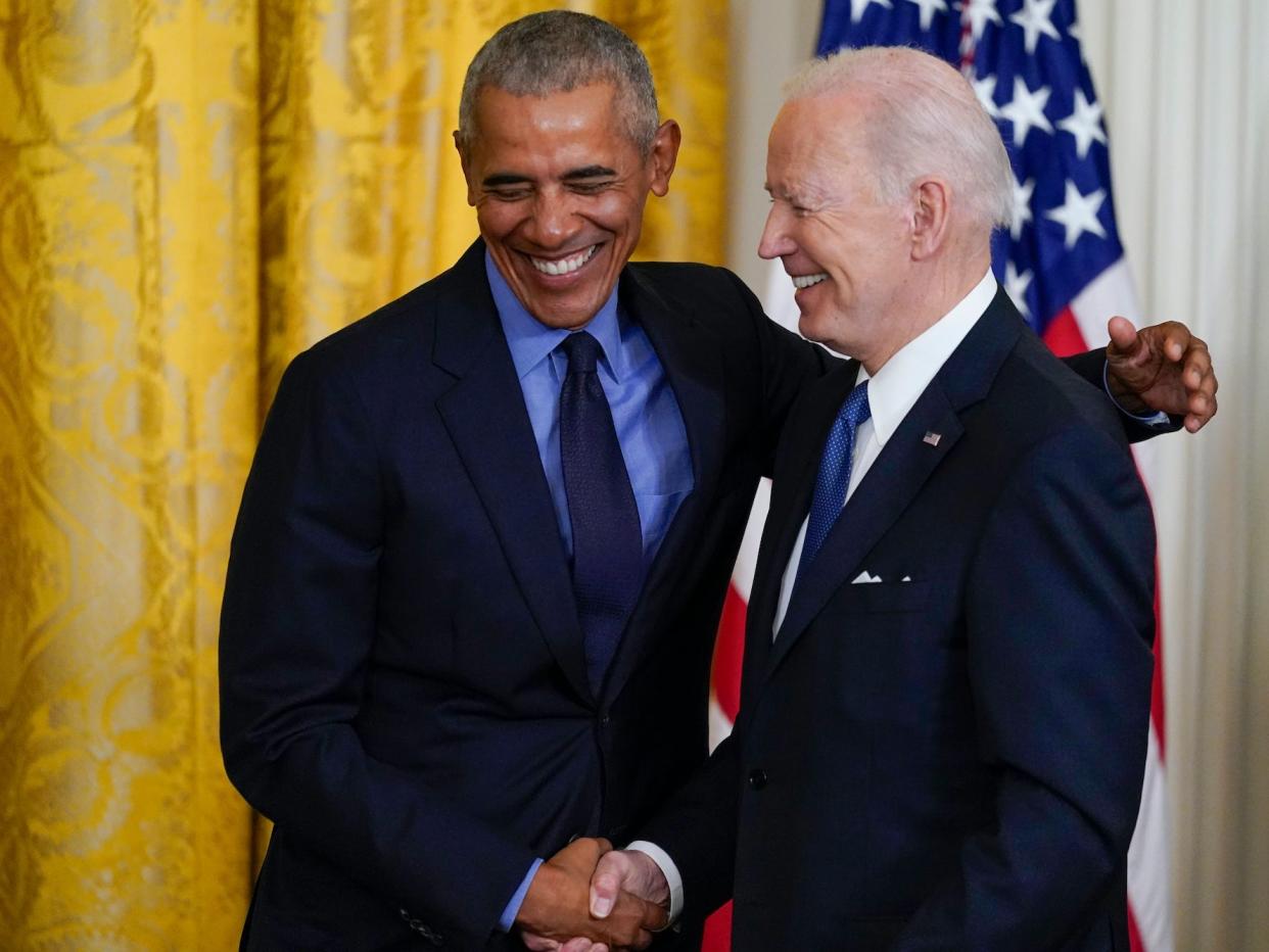 President Joe Biden and former President Barack Obama shake stand together on stage during an event about the Affordable Care Act, in the East Room of the White House in Washington, Tuesday, April 5, 2022.