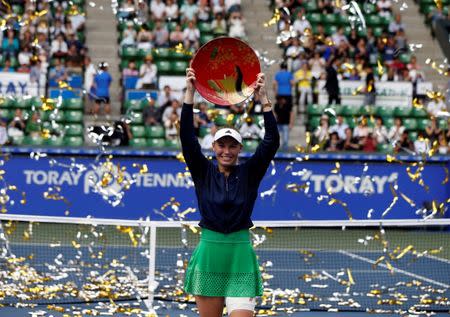 Tennis - Pan Pacific Open Women's Singles Final match - Ariake Coliseum, Tokyo, Japan - 25/09/16. Caroline Wozniacki of Denmark holds the winning plate during an awarding ceremony after winning the final match against Naomi Osaka of Japan. REUTERS/Issei Kato