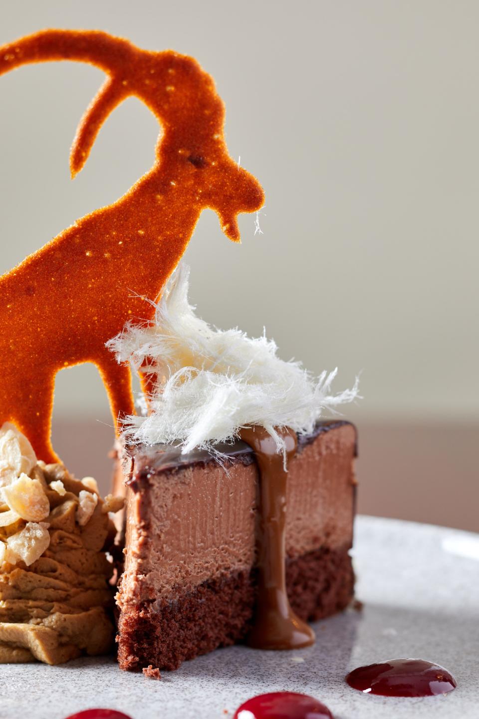 Chocolate mousse cake with goat milk caramel, raspberry, whipped cream and almonds from The GOAT in Union Beach.